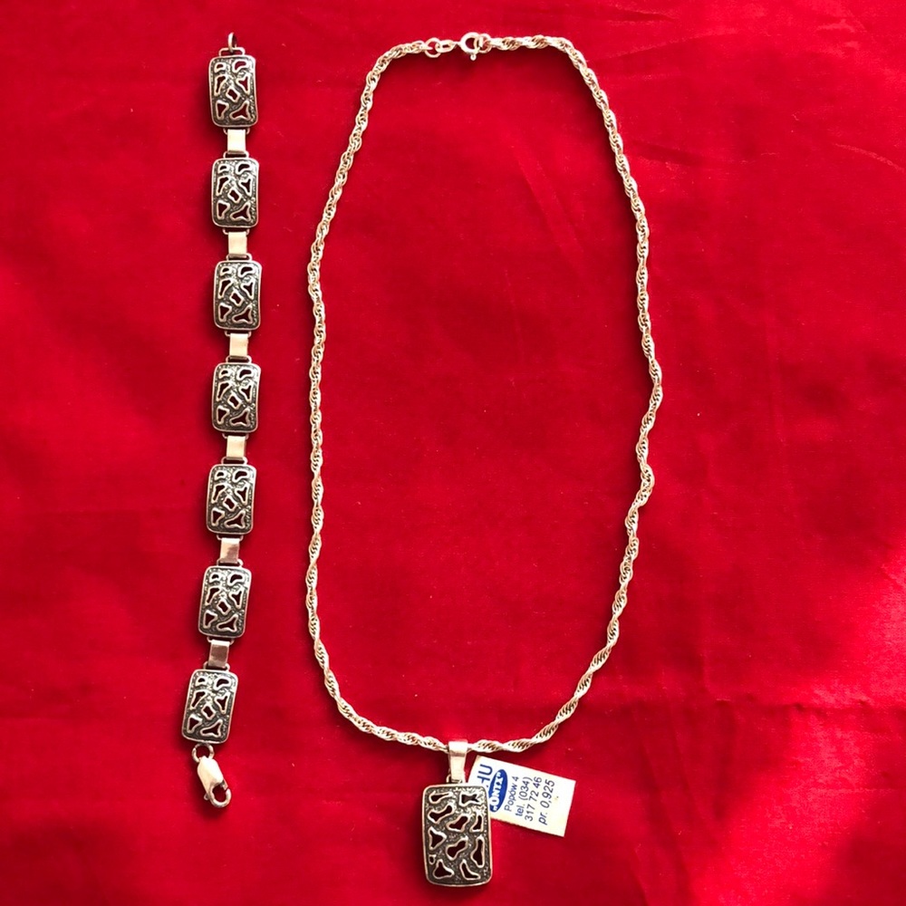 Silver necklace with silver pendant and matching silver bracelet.